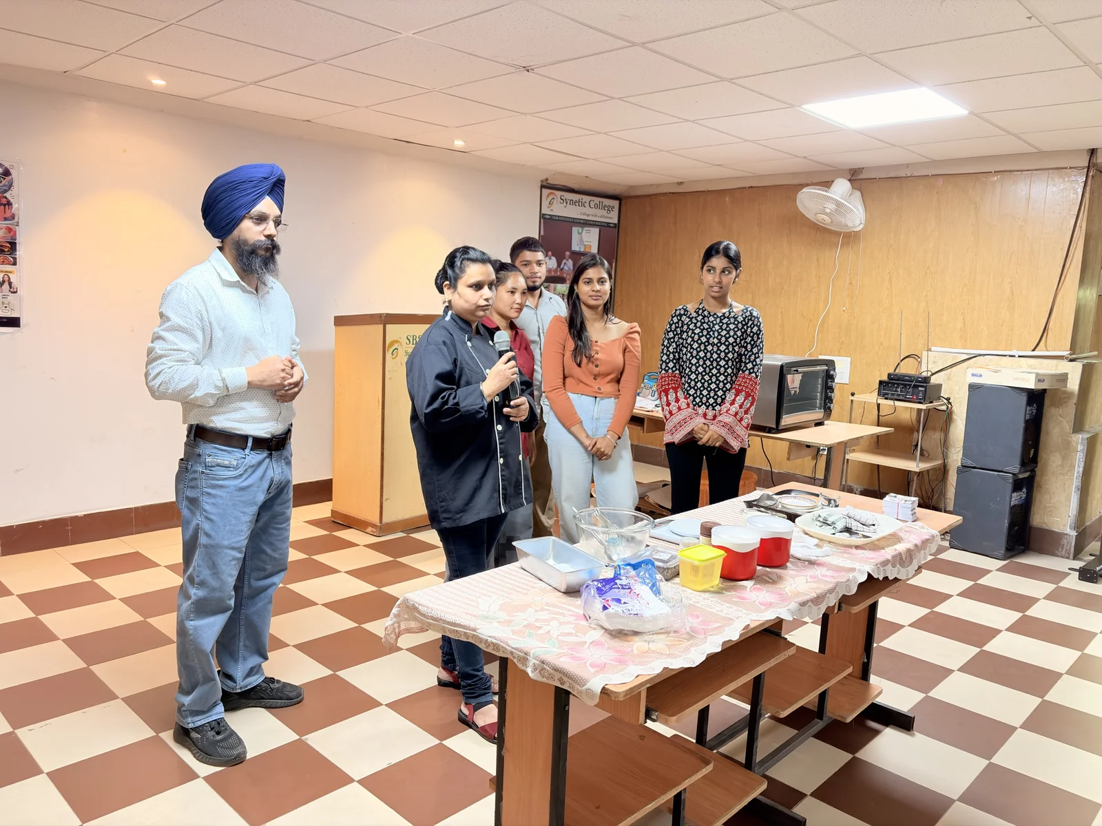 Chef Loveleen Kaur giving a live baking demonstration to SBS College students at the HR Kitchen Baking Workshop
