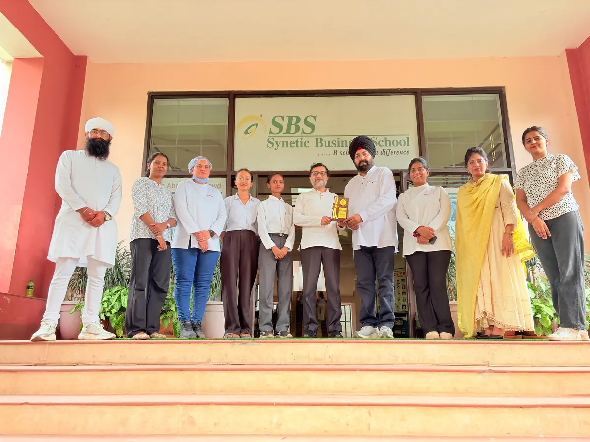 SBS faculty, students and the Thind Dental Clinic team with a memento outside the campus entrance