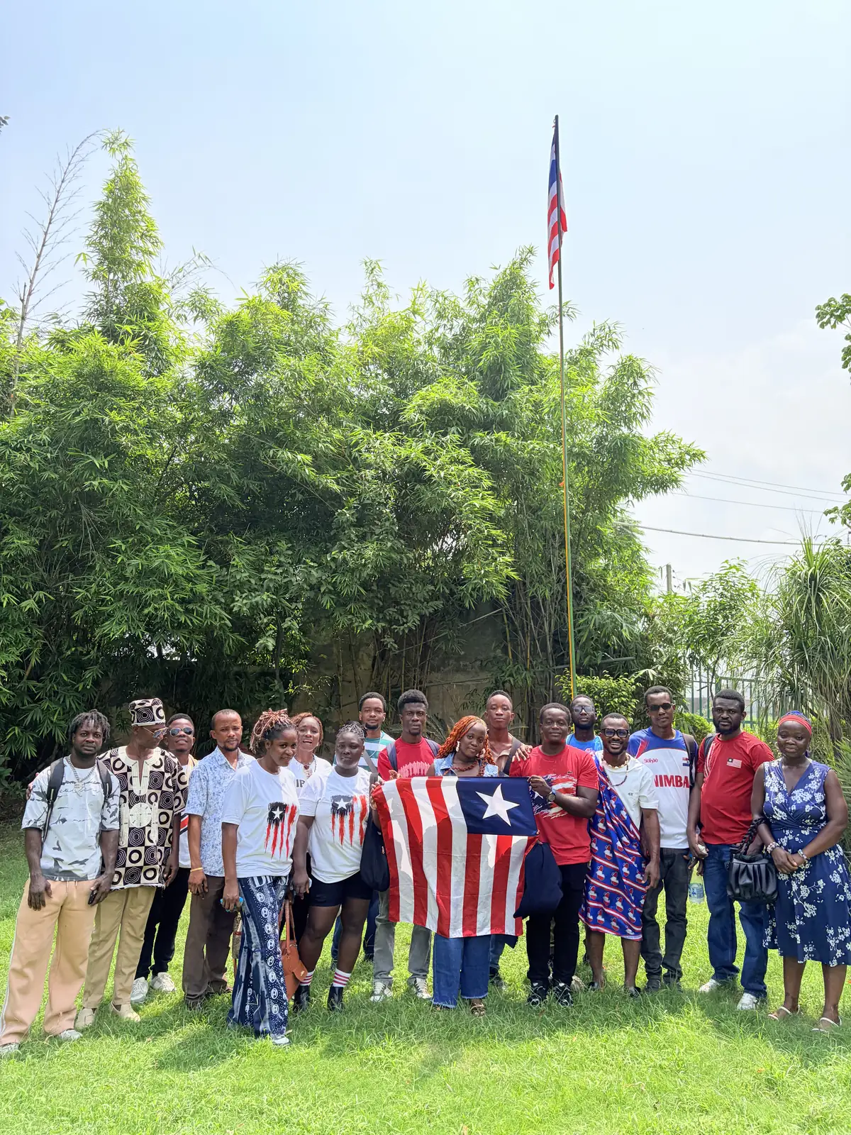 Liberian students at SBS holding the national flag on the campus lawn for Flag Day